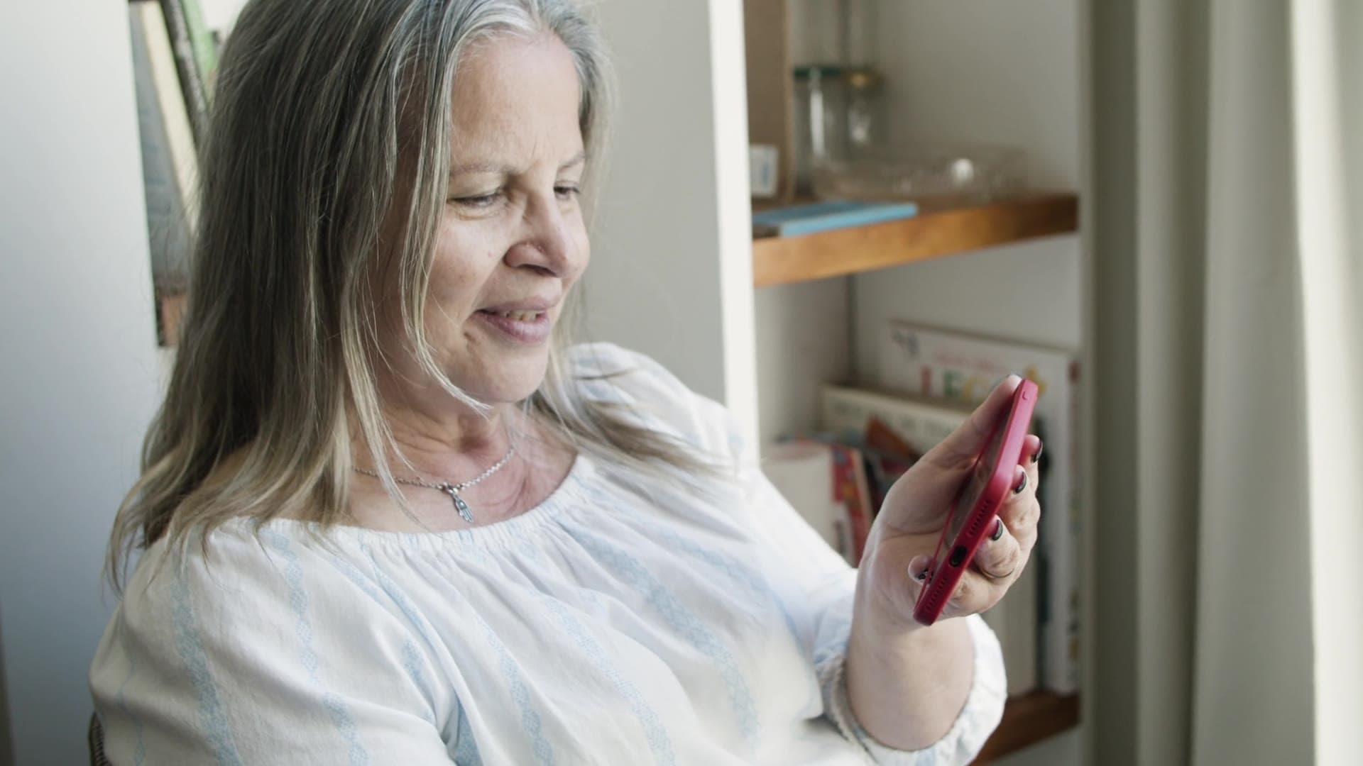 An older adult using a phone outdoors