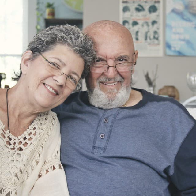 An older couple at home, smiling